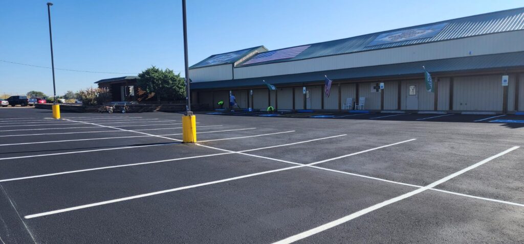 Freshly sealcoated parking lot at Cannabis Depot in Pueblo, Colorado, with smooth blacktop finish.