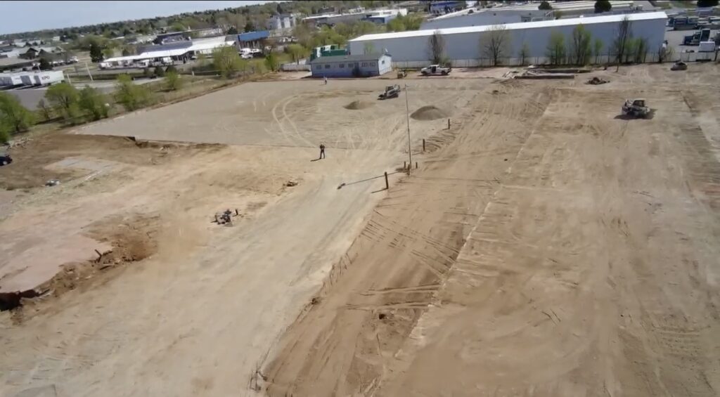 Aerial view of asphalt parking lot site preparation in Colorado Springs