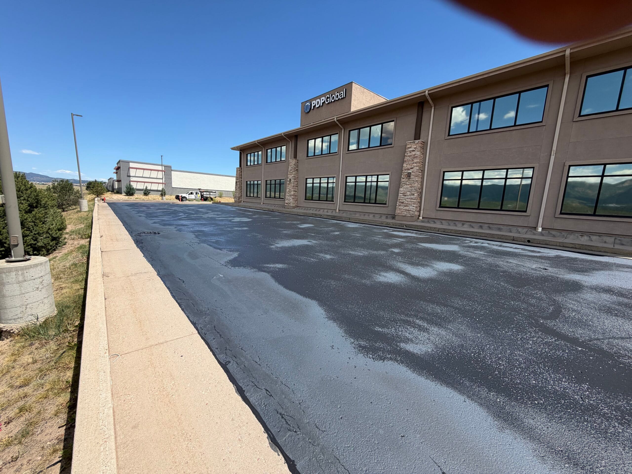 Two-coat asphalt emulsion sealer applied to commercial lot Colorado Springs