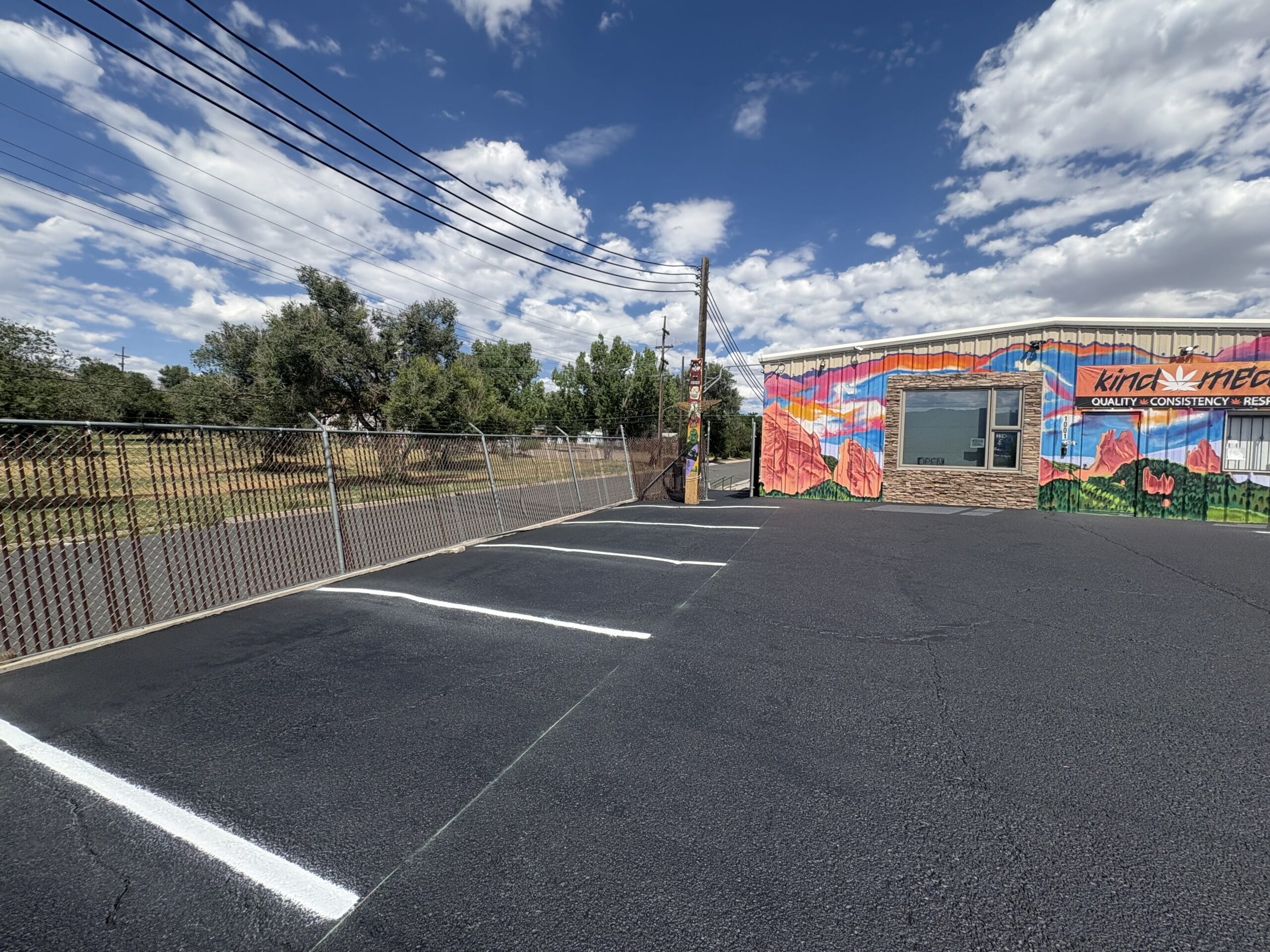 Machine applied line striping on fresh sealcoat Colorado Springs