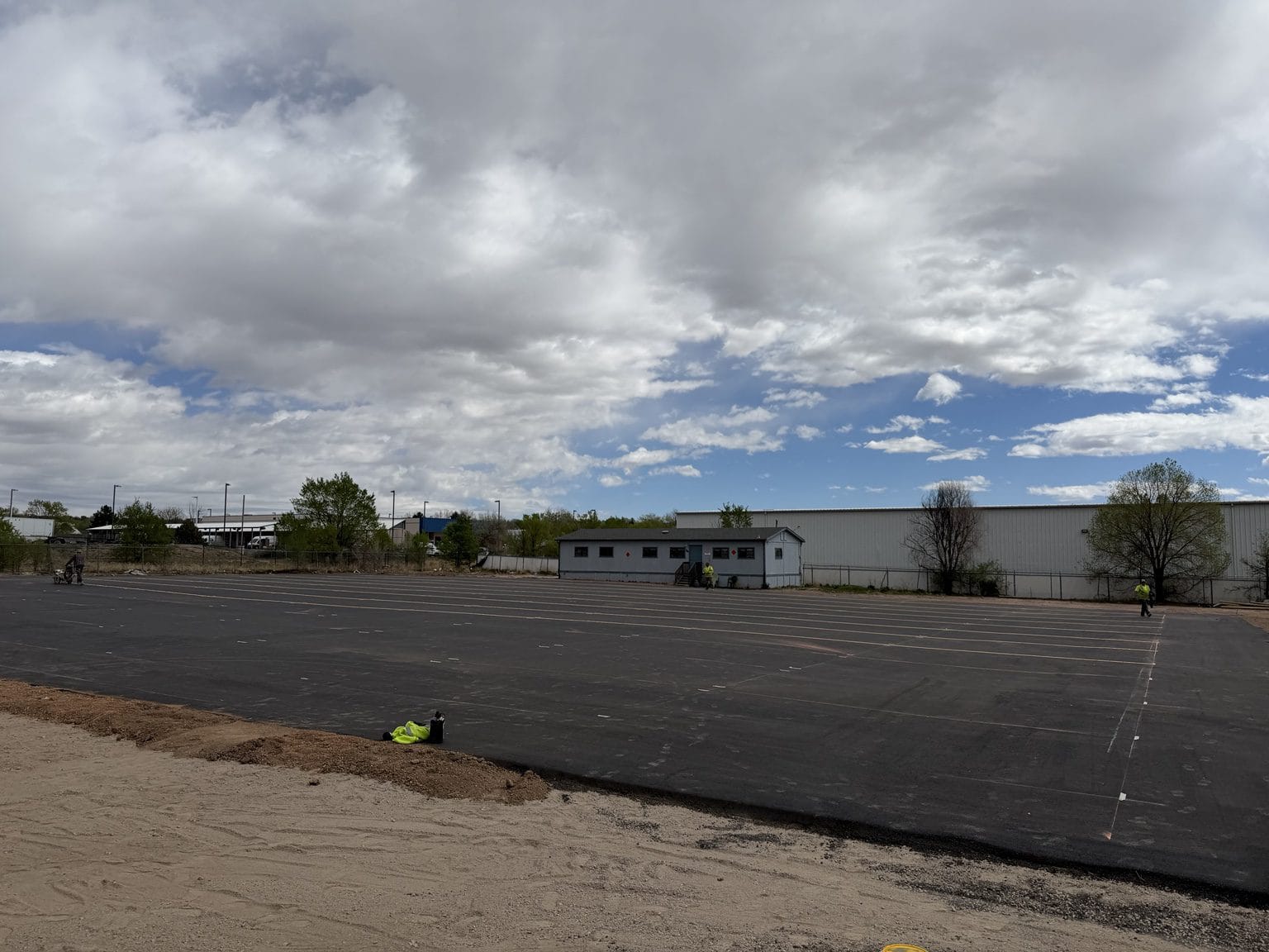 Fresh asphalt pavement and prepared shoulder at The CDL School