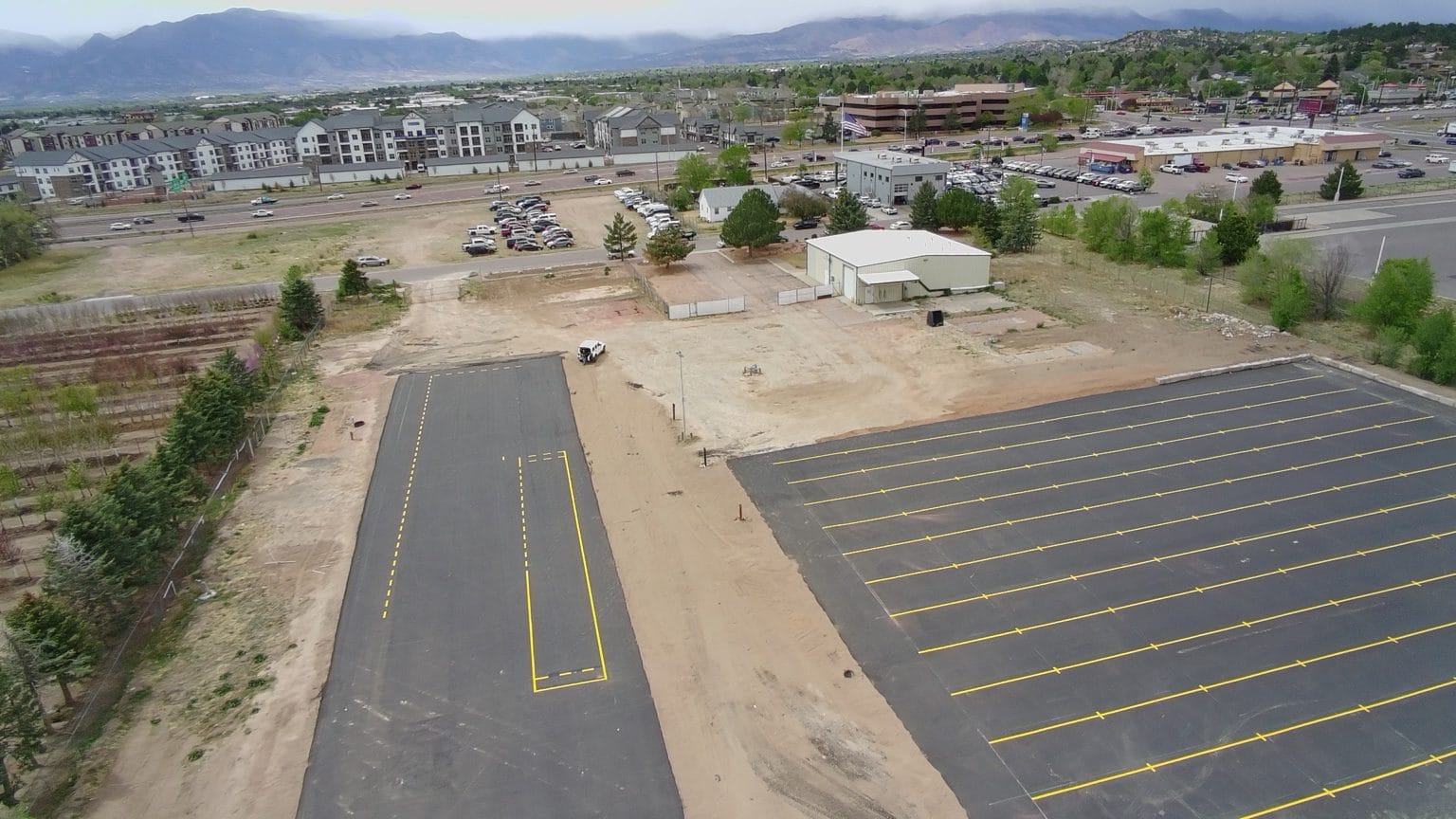 Wide aerial view of The CDL School asphalt and striping project